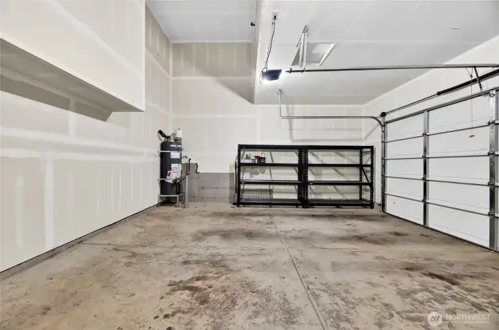 2- Car Garage has incredibly tall ceilings.  Storage Racking comes with house