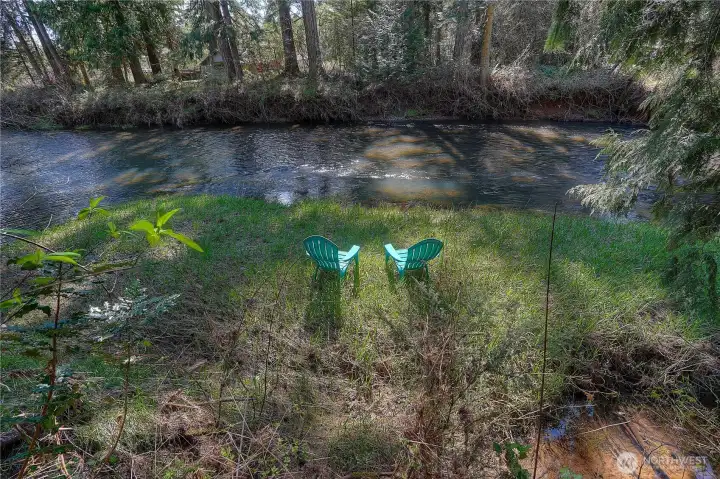 Peaceful river frontage with your own private spot to relax, unwind, and enjoy the soothing sounds of the water—perfect for quiet mornings, fishing, or simply taking in the natural beauty.    Private riverside setting with a peaceful seating area, an ideal spot to unwind, enjoy nature, and take in the calming views right from your own backyard.