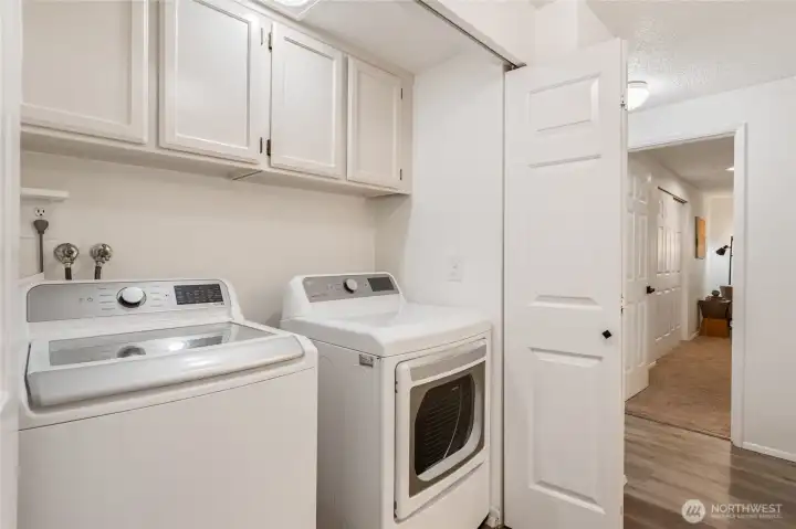 A newer washer and dryer are tucked away discreetly in a closet, and are included in the sale.
