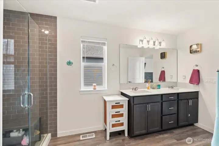 Large primary suite featuring an oversized subway-tiled shower. Large primary suite featuring an oversized subway-tiled shower.