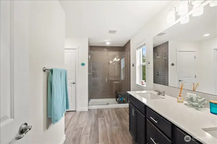 Oversized primary shower finished with classic subway tile detailing. Oversized primary shower finished with classic subway tile detailing.