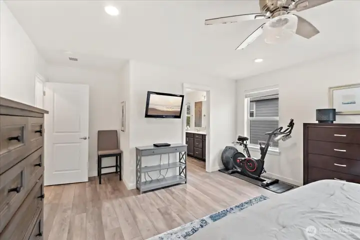 Spacious Primary Suite with LVP flooring and a ceiling fan. Spacious Primary Suite with LVP flooring and a ceiling fan.