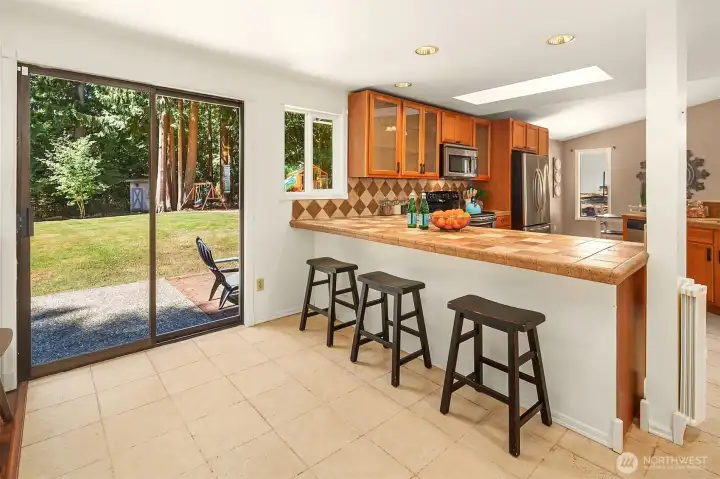 Pull up a stool to the kitchen or head out the slider to the patio. Pull up a stool to the kitchen or head out the slider to the patio.
