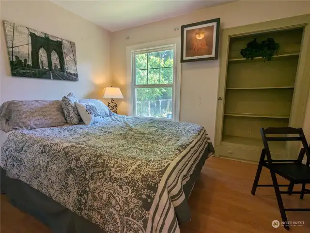 This is a queen size bed and there is a vent on the far wall that is part of the mini-split heating/cooling system. The built in closet is a fashion of the period design, and there is space for a desk at the right of the picture.