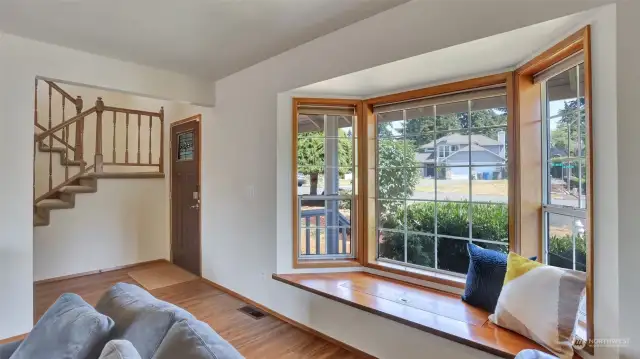 Enter to newer LVP flooring throughout the main level and take in the picturesque neighborhood from this darling window seat.