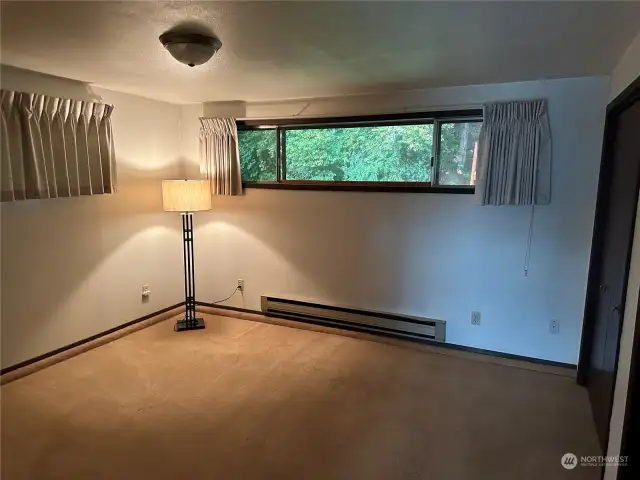 Primary bedroom has view of the forest