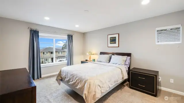 This bedroom features a window with a view of the outside.