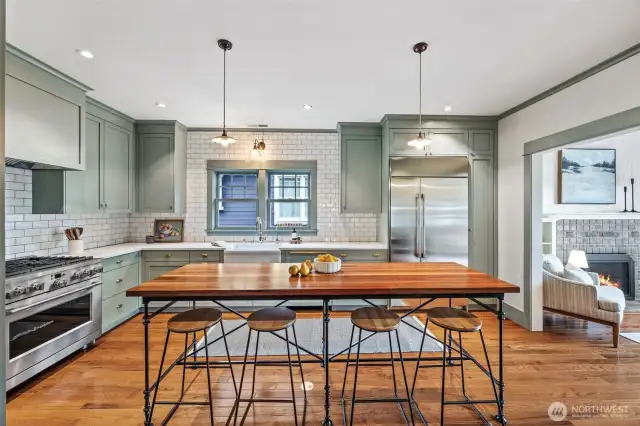 Stunning kitchen features 36" range, oversize refrigerator, wine fridge, an abundance of storage, and large, custom walnut island.