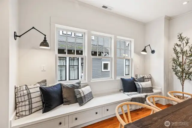 Cozy dining room features built-in bench with storage drawers