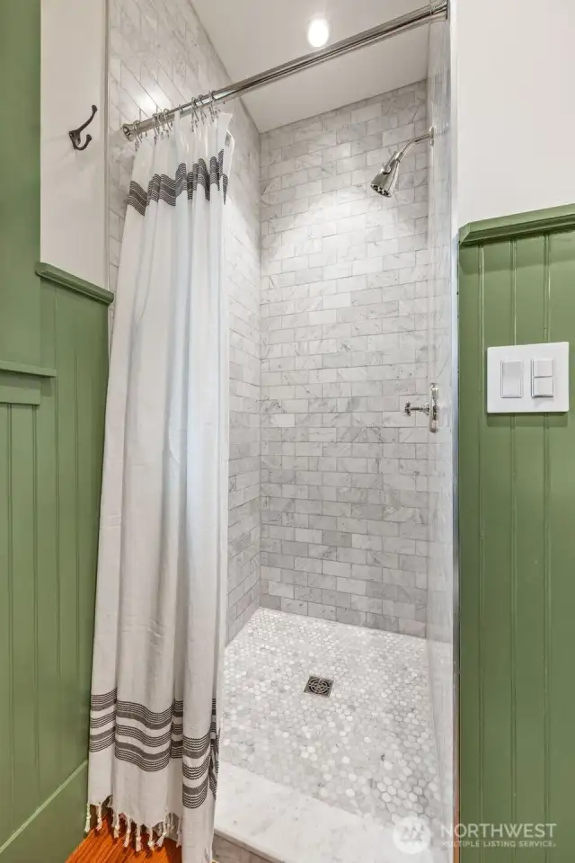 Main-level 3/4 bath with gorgeous marble shower