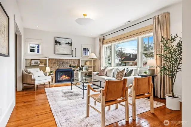 South-Facing Living Room features original Batchedler tile with updated gas fireplace.