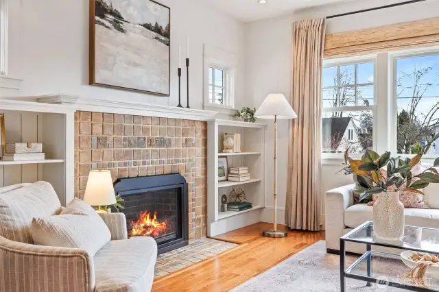 South-Facing Living Room features original Batchedler tile with updated gas fireplace.