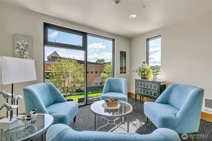 3rd floor gathering space with view of the library next door.