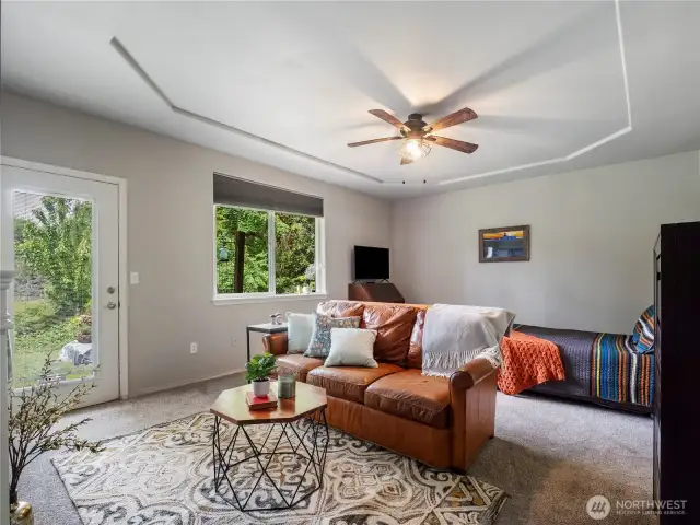 The primary bedroom has plenty of space to create a private space. Snuggle up to the fireplace after using the hot tub, which is accessed through the glass door.