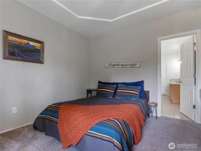 There is plenty of room for a king-sized bed and side table by placing the head of the bed on the longer wall.