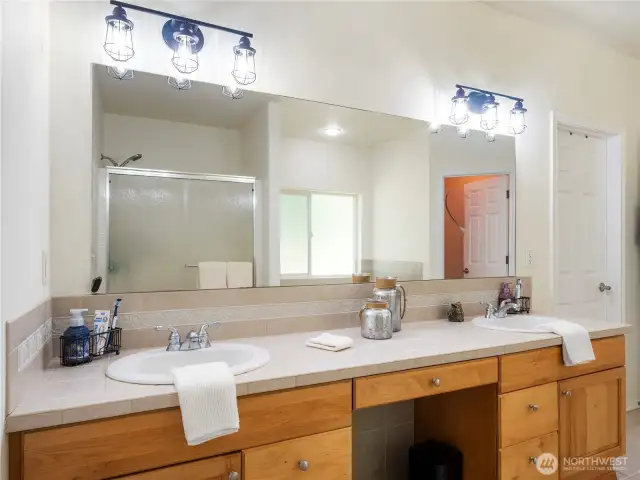 5-piece ensuite features stone tile floors, maple cabinets, double sinks, a soaking tub, walk-in closet, and private toilet.