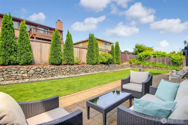 Professionally landscaped backyard offers privacy and serenity
