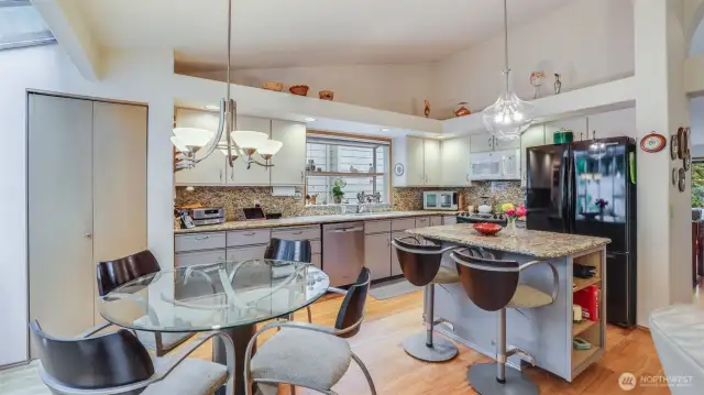 The kitchen area is open and airy.  nicely updated, hardwood floors, center island with granite counter tops.