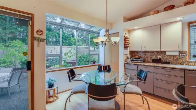 The eating nook is the perfect spot to enjoy the serene private views from inside and outside of this home.  Plenty of storage and a pantry.  The eat nook has a perfect window wall with peaceful views into the backyard.