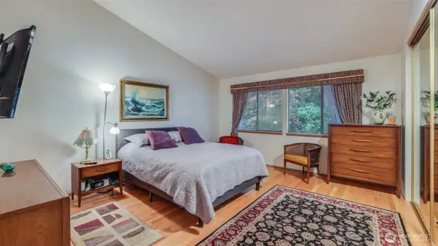 The primary bedroom is very spacious with a wonderful vaulted ceiling and a ample glass mirrored closet.