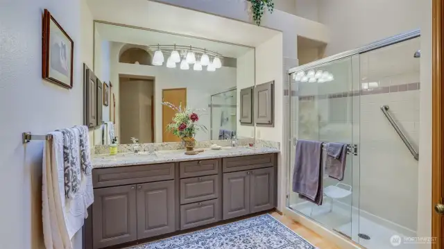 The primary bath has hardwood floors granite counter tops, tall ceiling, walk-in closet and updated fresh look.