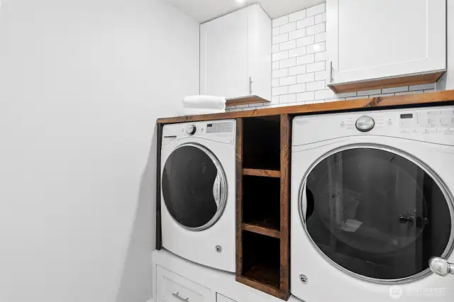 Second floor laundry with plenty of storage.