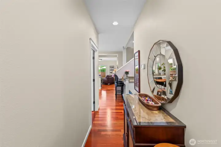 Main level hallway leading to 2nd guest bedroom, laundry, full bathroom and garage.