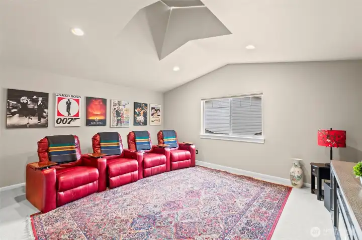 The spacious movie theatre room is also the 5th bedroom with walk-in California closet. All four (4) reclining movie chairs convey with the sale of this home.