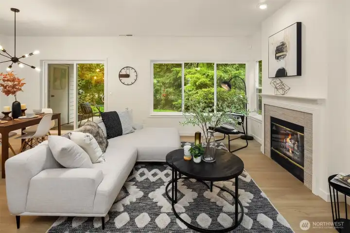 Large living room area, with focal gas fireplace for cozy nights in. Large picture windows offer views to the HOA maintained greenspace