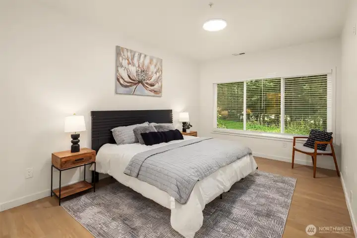 Large primary suite overlooking the greenspace, offering maximum privacy. Plenty of room for lounge chairs or additional dressers as needed