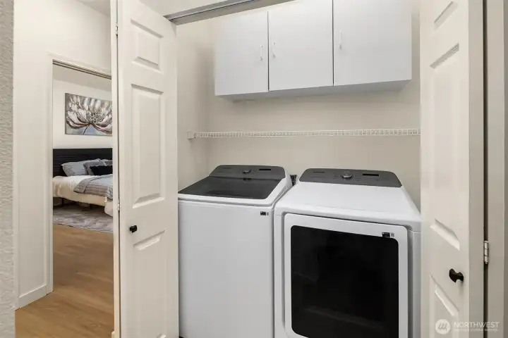 Full size washer and dryer with lots of storage space for laundry and cleaning supplies