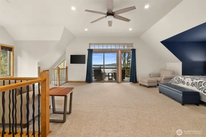Beautiful primary bedroom with sitting area & outdoor deck.