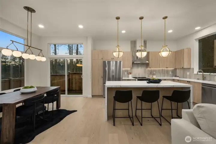 Chef's kitchen opens to the living and dining areas.