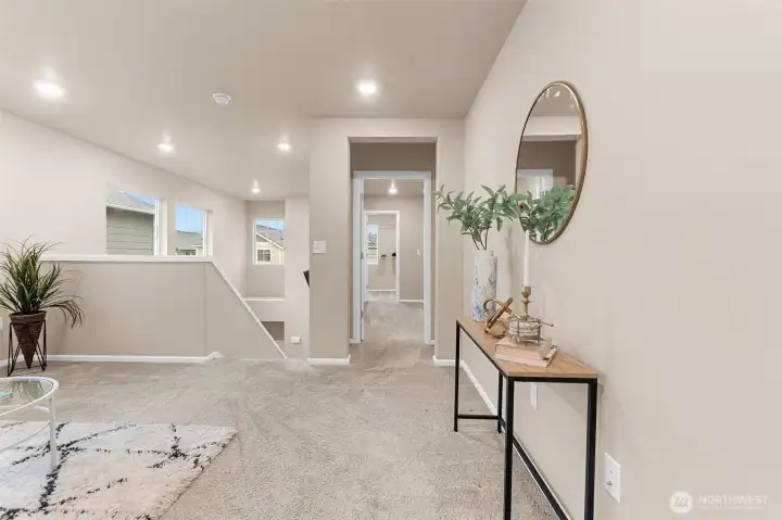 View towards the stairs to the left, and the primary suite entrance to the right.