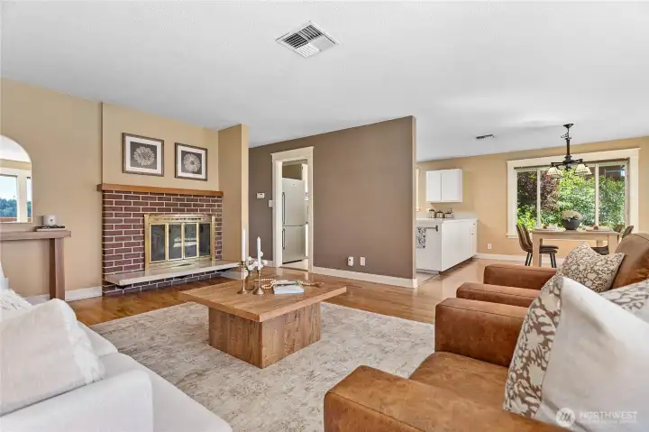 Enjoy an airy, light-filled living space with large windows showing scenic views and the surrounding garden landscape