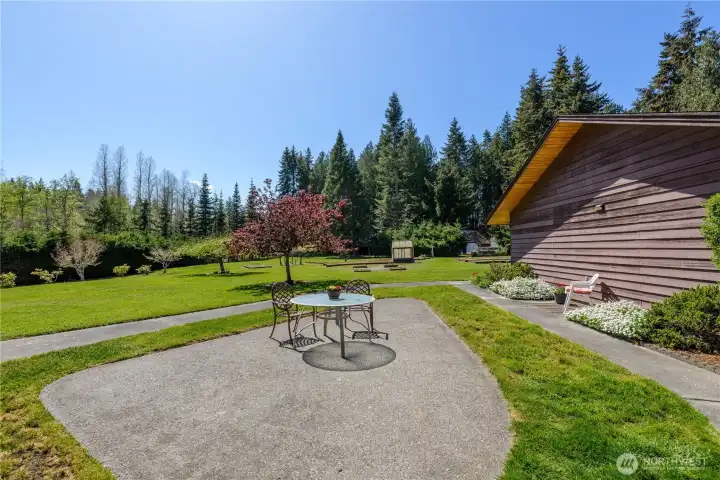 Expansive backyard, perfect for hosting with a view of the raised beds, grape vines and apple tree and thoughtful landscape trees and shrubbery Expansive backyard, perfect for hosting with a view of the raised beds, grape vines and apple tree and thoughtful landscape trees and shrubbery