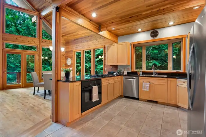 The open kitchen is designed for everyday living and entertaining, featuring ample workspace, quality cabinetry, and seamless flow to the dining and living areas.