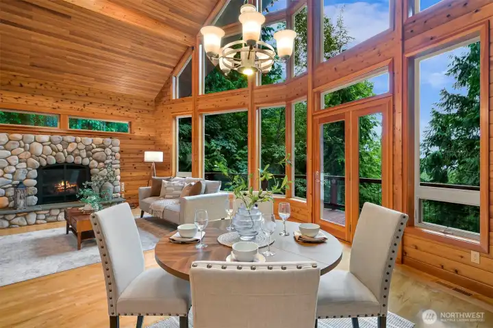 Gather for dinner while surrounded by soaring cedar ceilings, a striking wall of windows, and peaceful forest views that create a truly memorable setting.