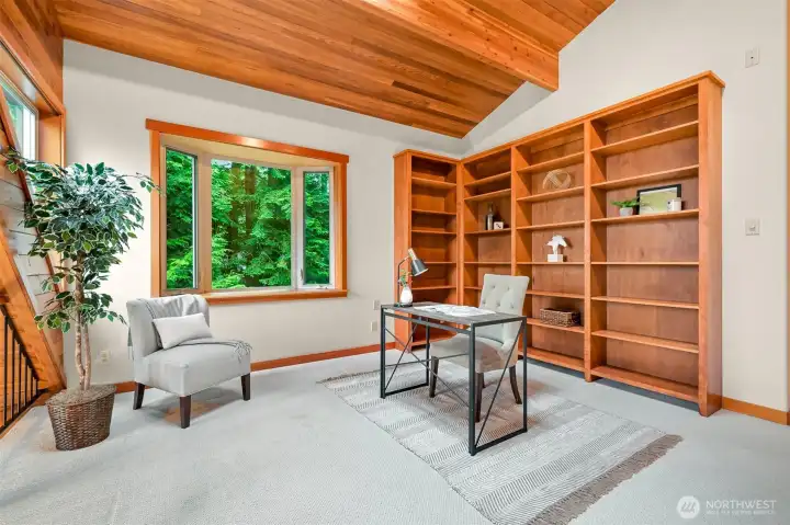 The open loft offers exceptional flexibility as a home office, reading retreat, creative studio, or additional gathering space overlooking the great room below.