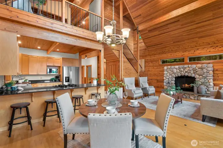 The open-concept layout connects the kitchen, dining, and great room, making it easy to entertain while enjoying the warmth and character of the timber interior.