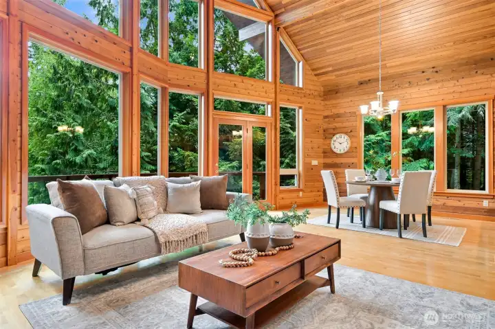 Designed for both everyday living and entertaining, this open-concept great room seamlessly connects the living, dining, kitchen, and loft spaces beneath soaring cedar ceilings.