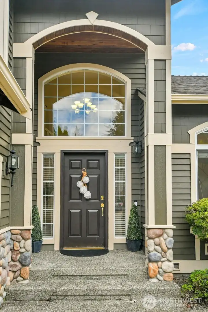 An impressive covered entry with rich wood accents leads to a spectacular two-story foyer, where soaring ceilings and a dramatic arched window create a memorable first impression. An impressive covered entry with rich wood accents leads to a spectacular two-story foyer, where soaring ceilings and a dramatic arched window create a memorable first impression.