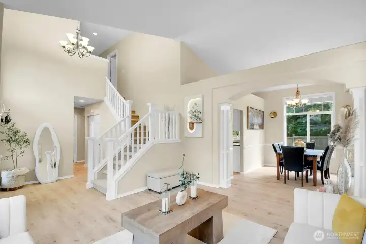 Dramatic two-story living room with soaring ceilings, expansive windows, and a grand entry filled with natural light. Dramatic two-story living room with soaring ceilings, expansive windows, and a grand entry filled with natural light.