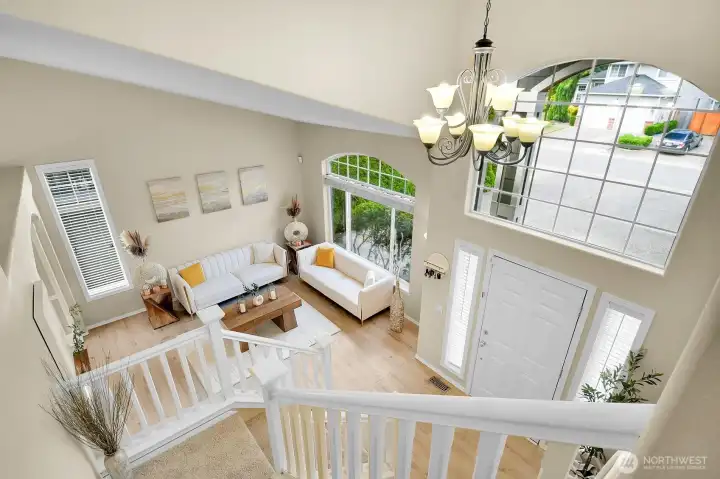 An open, airy design showcases the impressive two-story foyer and living room below, creating a bright and welcoming first impression. An open, airy design showcases the impressive two-story foyer and living room below, creating a bright and welcoming first impression.