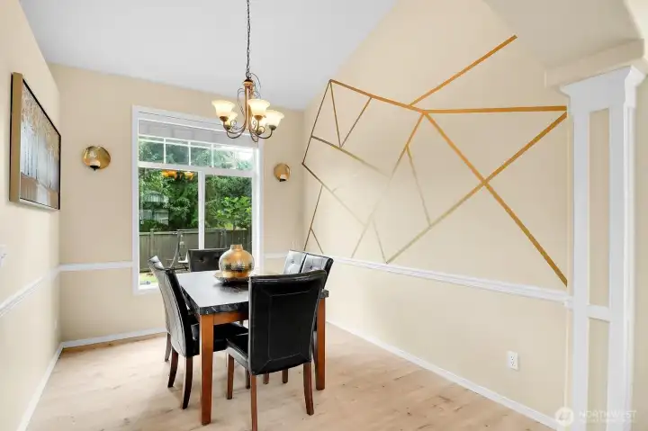 Elegant formal dining room featuring a custom accent wall, abundant natural light, and the perfect setting for family dinners and entertaining. Elegant formal dining room featuring a custom accent wall, abundant natural light, and the perfect setting for family dinners and entertaining.