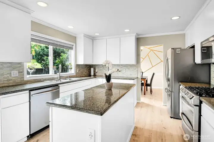 The heart of the home, this beautifully updated kitchen offers generous prep space, ample storage, and overlooks the backyard. The heart of the home, this beautifully updated kitchen offers generous prep space, ample storage, and overlooks the backyard.