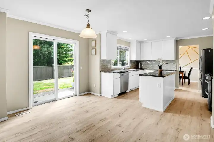 Bright, open kitchen with abundant natural light, spacious eating area, and easy access to the backyard for seamless indoor outdoor living. Bright, open kitchen with abundant natural light, spacious eating area, and easy access to the backyard for seamless indoor outdoor living.