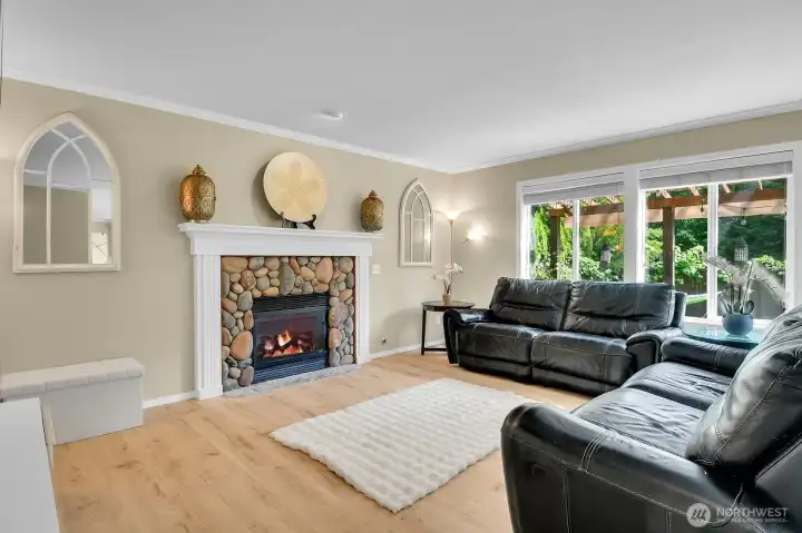 Inviting family room featuring a beautiful river rock gas fireplace and plenty of space for relaxing or entertaining. Inviting family room featuring a beautiful river rock gas fireplace and plenty of space for relaxing or entertaining.