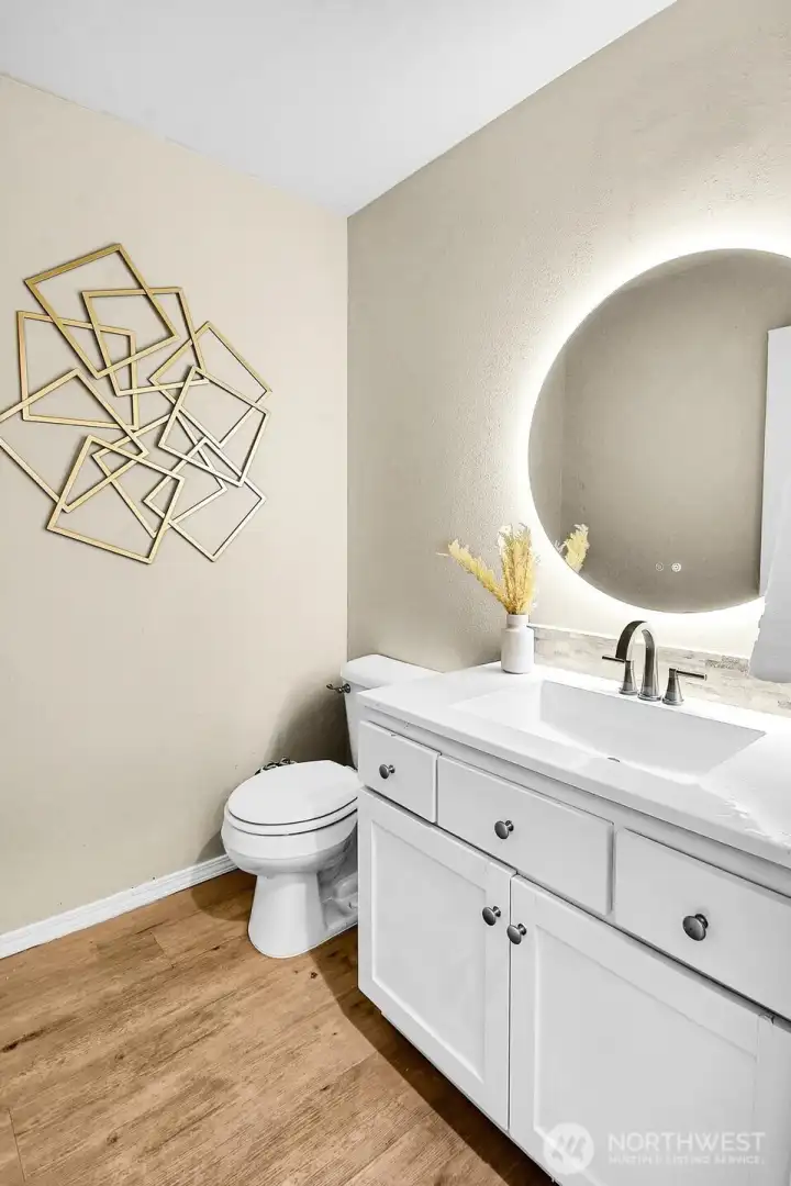 Beautifully updated main floor powder room featuring a modern vanity, designer mirror, and stylish finishes. Beautifully updated main floor powder room featuring a modern vanity, designer mirror, and stylish finishes.