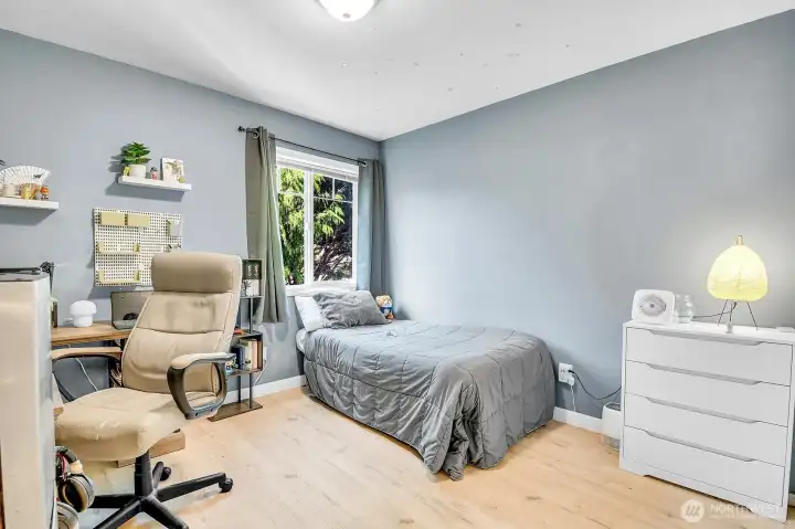 Bright secondary bedroom with luxury vinyl plank flooring and abundant natural light. Bright secondary bedroom with luxury vinyl plank flooring and abundant natural light.